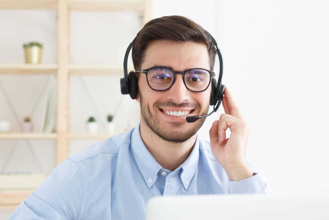 Young IT support employee smiling with headset