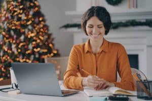 smiling remote employee in front of Christmas tree