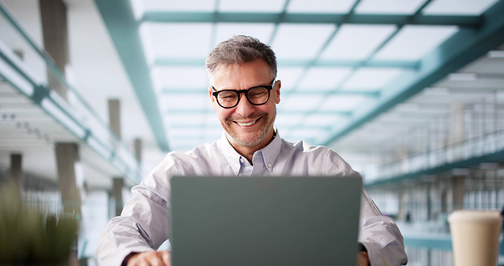 man at his computer receiving IT managed services help remotely