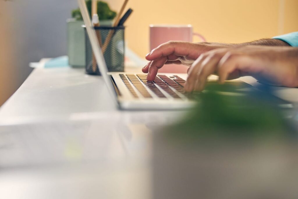 Hands typing on a keyboard